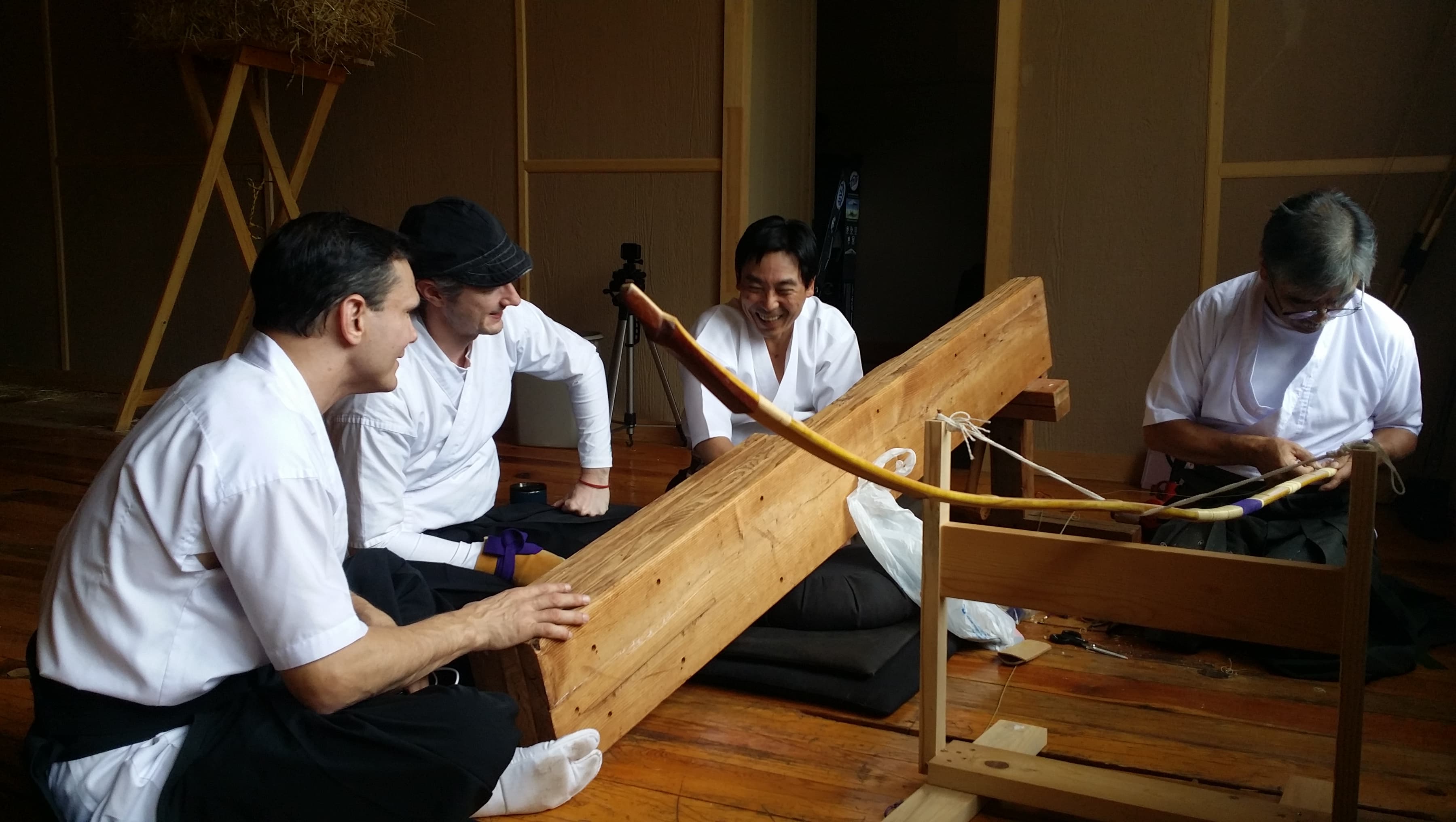 Shibata-sensei repairs a yumi while Jason, John, and Yasuo look on. Shibata-sensei repairs a yumi while Jason, John, and Yasuo look on.