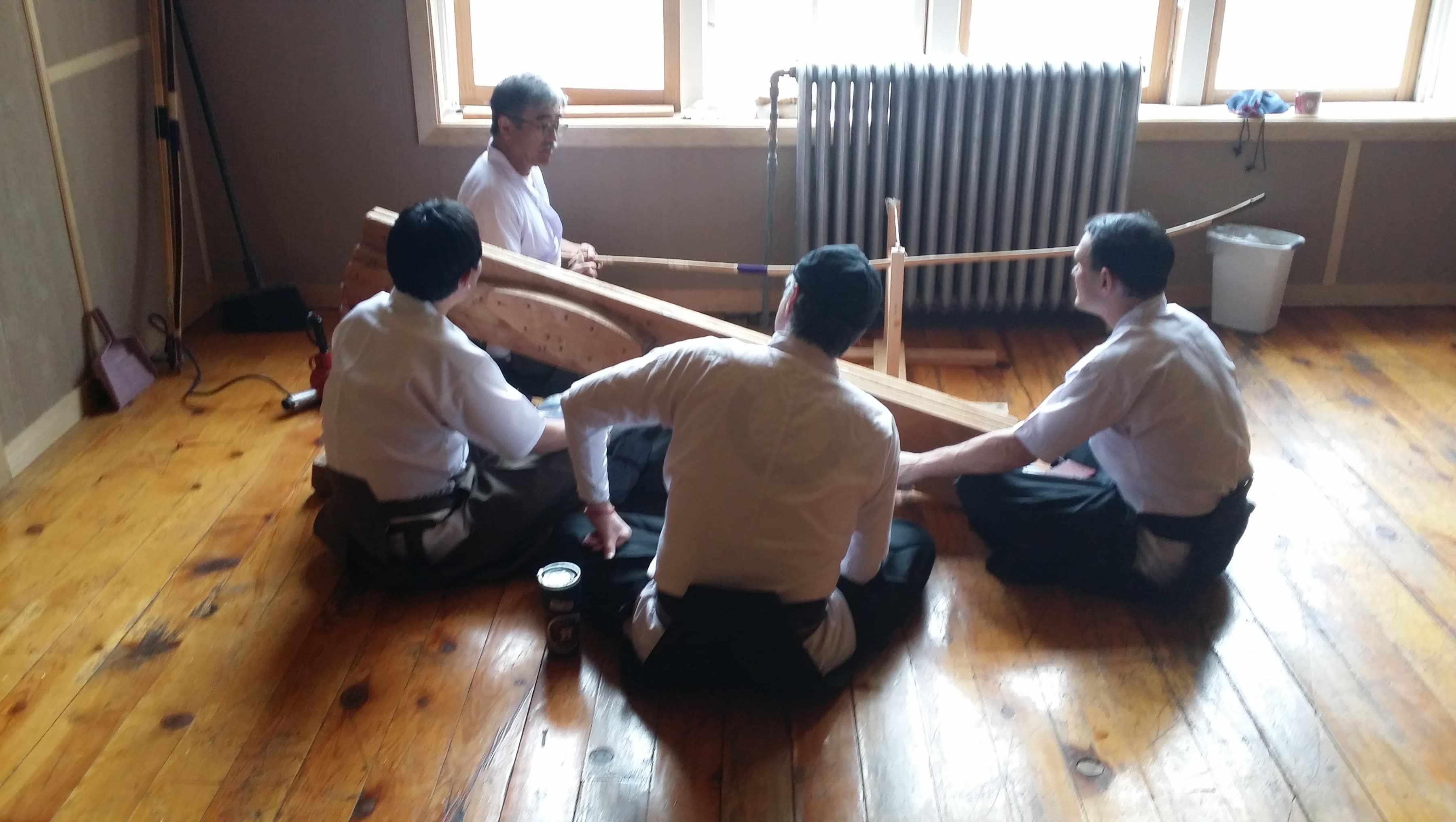 Shibata-sensei repairs a yumi while Jason, John, and Yasuo look on. Shibata-sensei repairs a yumi while Jason, John, and Yasuo look on.